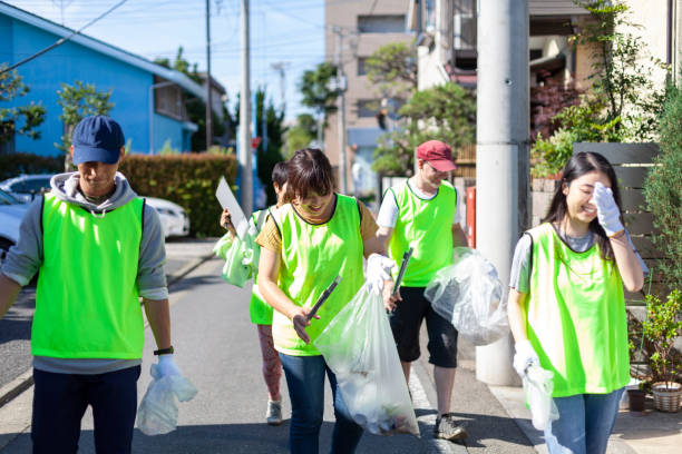 The Ultimate Eco-Volunteer Checklist: What to Pack for Your First Cleanup a group of volunteers are cleaning up the streets in tokyo.